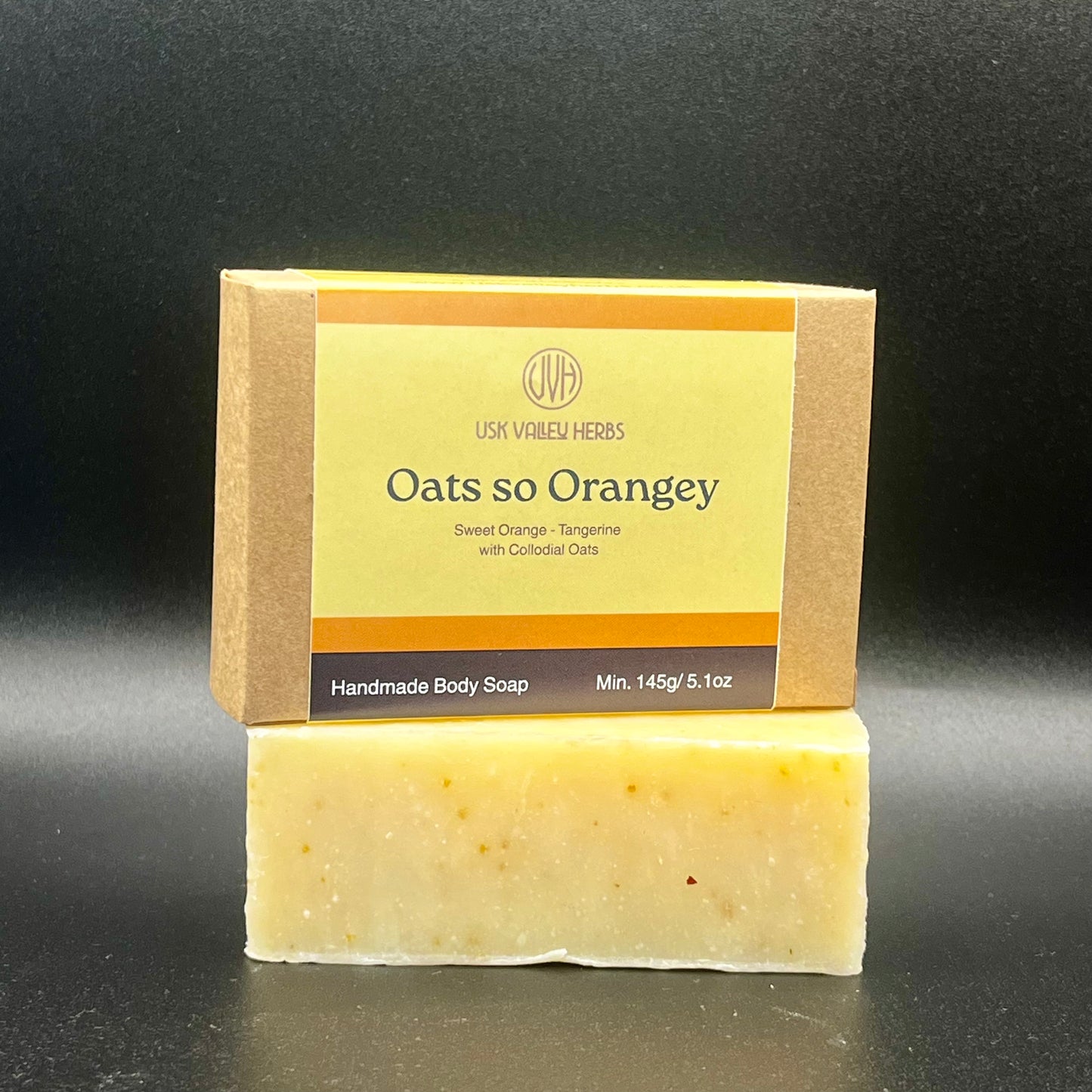 Oat so Orangey natural handmade soap bar with soft orange tones and visible oats, scented with sweet orange and Tangerine essential oil, made by Usk Valley Herbs in the Brecon Beacons