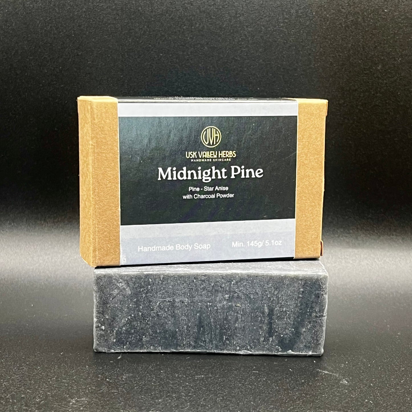 A bar of Midnight Pine natural herbal soap made with charcoal powder and oils of Pine and Anise for fishermen and farmers