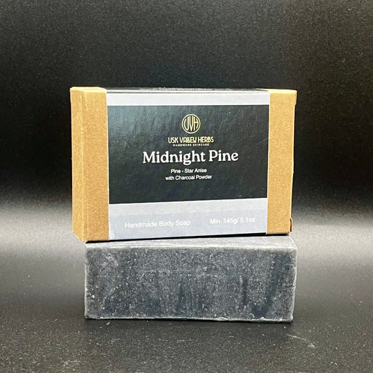 A bar of Midnight Pine natural herbal soap made with charcoal powder and oils of Pine and Anise for fishermen and farmers