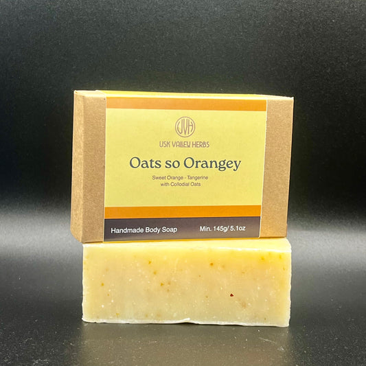 Oat so Orangey natural handmade soap bar with soft orange tones and visible oats, scented with sweet orange and Tangerine essential oil, made by Usk Valley Herbs in the Brecon Beacons